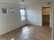 Bright bedroom featuring wood-look floors, two windows and a walk-in closet at 4995 S Algonquian Way, Aurora, CO 80016