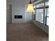 Bright living room with large windows, a fireplace, plush carpet, and modern lighting for a welcoming atmosphere at 4995 S Algonquian Way, Aurora, CO 80016