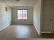 Well-lit living room with wood-look floors and bright, natural light at 4995 S Algonquian Way, Aurora, CO 80016