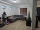 Spacious living room with hardwood floors, a large sectional couch, and a wall-mounted TV at 4995 S Algonquian Way, Aurora, CO 80016