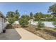 Spacious backyard with a concrete patio area, white fence, and potential for landscaping at 1101 Dakin St, Denver, CO 80221