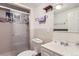 Well-lit bathroom features a glass-enclosed shower, toilet, and sink with a sleek design at 1101 Dakin St, Denver, CO 80221