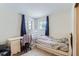 Modest bedroom features a simple desk, chair, and bed, perfect for a or single adult at 1101 Dakin St, Denver, CO 80221