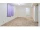 A simple carpeted bedroom with access to another room at 1101 Dakin St, Denver, CO 80221