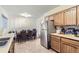 Spacious kitchen with stainless steel refrigerator, dining area and functional cabinets at 1101 Dakin St, Denver, CO 80221