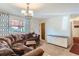 Bright living room featuring a plush sectional sofa, modern lighting, and practical storage cabinet at 1101 Dakin St, Denver, CO 80221