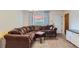 Comfortable living room featuring a plush sectional sofa, chandelier lighting, and natural light from a window at 1101 Dakin St, Denver, CO 80221