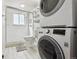 Bright bathroom features a glass enclosed shower and stacked washer/dryer at 33 N Corona St # 404, Denver, CO 80218