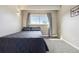 Bedroom with a cozy bed, bright window, and carpeted flooring at 33 N Corona St # 404, Denver, CO 80218