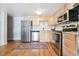 Bright and spacious kitchen with stainless steel appliances and light wood cabinets at 33 N Corona St # 404, Denver, CO 80218