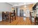 Kitchen and dining area with stainless steel appliances and light wooden cabinets at 33 N Corona St # 404, Denver, CO 80218