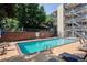 Enjoy the community pool, surrounded by lounge chairs and a privacy fence at 33 N Corona St # 404, Denver, CO 80218