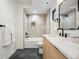 Bright bathroom featuring a shower over tub, modern fixtures, and sleek tile at 1745 Lowell Blvd, Denver, CO 80204