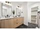 Bathroom with double vanity, sleek countertops and mirrors, and a closet at 1745 Lowell Blvd, Denver, CO 80204