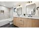 Modern bathroom features a double sink vanity with light wood cabinets and modern fixtures at 1745 Lowell Blvd, Denver, CO 80204