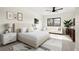 Staged bedroom showcasing modern decor, neutral tones, and large windows at 1745 Lowell Blvd, Denver, CO 80204
