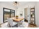 Bright dining room features modern light fixture, light wood table with seating for four and sliding glass door to patio at 1745 Lowell Blvd, Denver, CO 80204