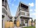 Modern three-story home featuring a covered porch and second-floor balcony at 1745 Lowell Blvd, Denver, CO 80204