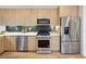 Updated kitchen features stainless steel appliances and light wood cabinetry at 1745 Lowell Blvd, Denver, CO 80204