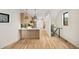 Bright, open-concept living room with hardwood floors, kitchen, and modern light fixtures at 1745 Lowell Blvd, Denver, CO 80204