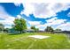 Spacious backyard with lush green grass, a concrete pad and privacy fencing at 1853 Burton St, Strasburg, CO 80136