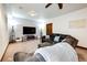 This is a carpeted basement featuring a brown sofa and an electric fireplace, with recessed lighting at 1853 Burton St, Strasburg, CO 80136