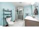 Stylish bathroom featuring blue walls, updated vanity, a glass-enclosed shower, and modern fixtures at 1853 Burton St, Strasburg, CO 80136