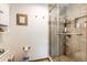 Modern bathroom with tiled shower, built-in shelves, and neutral tones for a soothing atmosphere at 1853 Burton St, Strasburg, CO 80136