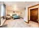 This bedroom is spacious and features a plush chair, closet and ceiling fan, offering relaxation and comfort at 1853 Burton St, Strasburg, CO 80136