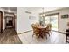 Inviting dining area with a wood table set, sliding glass doors for natural light, and tile flooring at 1853 Burton St, Strasburg, CO 80136