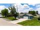Charming home exterior featuring a well-manicured lawn and inviting curb appeal at 1853 Burton St, Strasburg, CO 80136