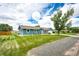 Charming blue ranch home featuring a well-manicured lawn and inviting curb appeal at 1853 Burton St, Strasburg, CO 80136