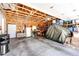 Spacious garage with workbench, shelving, and ample storage space for tools and equipment at 1853 Burton St, Strasburg, CO 80136