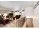 Inviting living room with hardwood floors, large bay window, and stair access at 1853 Burton St, Strasburg, CO 80136