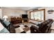 Comfortable living room with hardwood floors, bay window, and cozy fireplace at 1853 Burton St, Strasburg, CO 80136