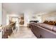 Open concept living room and dining area with hardwood floors and a view into the kitchen at 1853 Burton St, Strasburg, CO 80136
