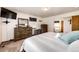 Spacious main bedroom featuring carpeted floors, wood furniture, and serene decor at 1853 Burton St, Strasburg, CO 80136