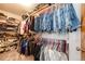 Organized walk-in closet featuring ample storage for shoes and hanging clothes at 1853 Burton St, Strasburg, CO 80136