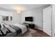 Staged bedroom featuring a large window, rug, and a tv on the dresser at 17004 E Tennessee Dr # 103, Aurora, CO 80017