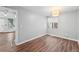 Neutral bedroom with hardwood floors, large window, and overhead lighting at 17004 E Tennessee Dr # 103, Aurora, CO 80017