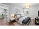 Staged bedroom featuring a large window, overhead lighting, and modern decor at 17004 E Tennessee Dr # 103, Aurora, CO 80017