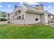 This shows the exterior of a nice, gray townhome with a lush green lawn and rocky beds at 17004 E Tennessee Dr # 103, Aurora, CO 80017