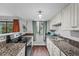 Well-lit kitchen featuring stainless steel appliances and granite countertops at 17004 E Tennessee Dr # 103, Aurora, CO 80017