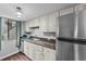 Modern kitchen with stainless steel refrigerator and granite countertops at 17004 E Tennessee Dr # 103, Aurora, CO 80017