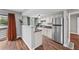 A kitchen featuring stainless steel appliances, white cabinets, and granite countertops at 17004 E Tennessee Dr # 103, Aurora, CO 80017