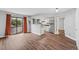 The living room is adjacent to the updated kitchen and has wood floors at 17004 E Tennessee Dr # 103, Aurora, CO 80017