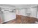 A living room and kitchen combination offers updated cabinets and wood floors at 17004 E Tennessee Dr # 103, Aurora, CO 80017