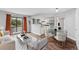 A modern living room with wood floors, a large window, and modern furnishings at 17004 E Tennessee Dr # 103, Aurora, CO 80017