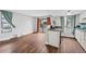 An open-concept living room and kitchen with wood floors and natural light at 17004 E Tennessee Dr # 103, Aurora, CO 80017