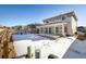 Spacious backyard with a large sunroom and snow-covered ground at 21837 E Stanford Cir, Aurora, CO 80015